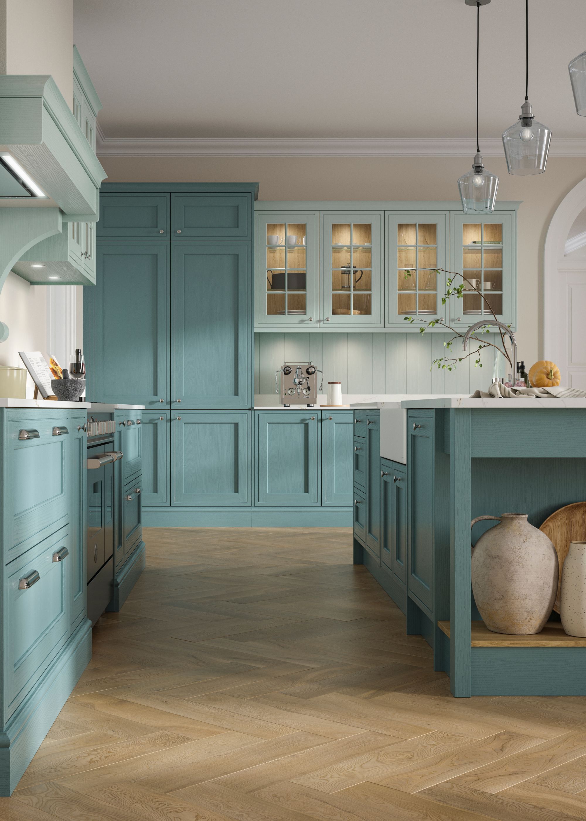 A light blue/teal colored kitchen with an island in the middle as well as lighter colored glass fronted cabinets on one side of the kitchen
