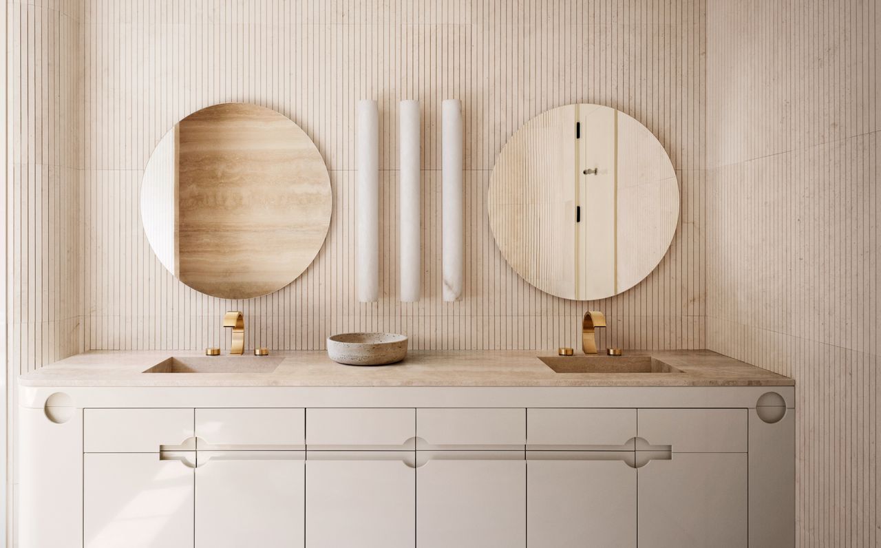 A bathroom with plaster walls and two round mirrors 