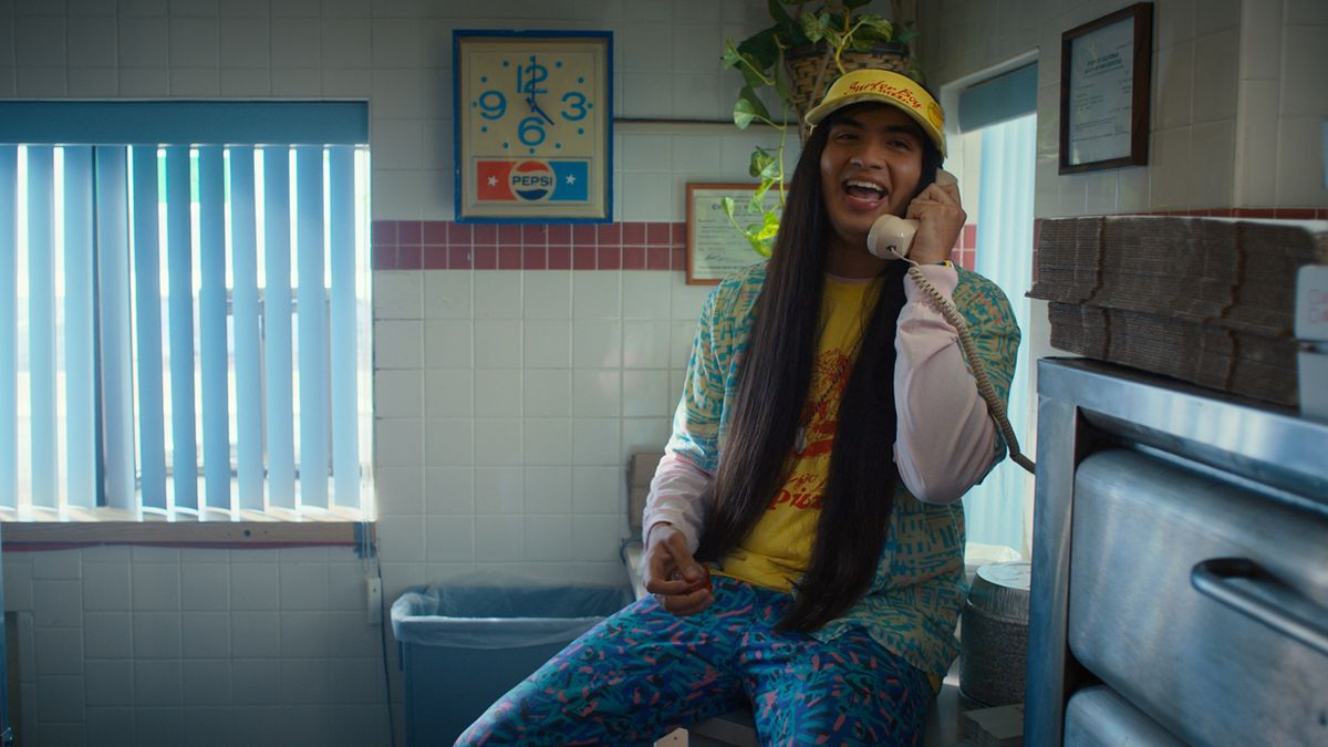 Argyle laughs on the phone to a friend during a work break in Stranger Things season 4
