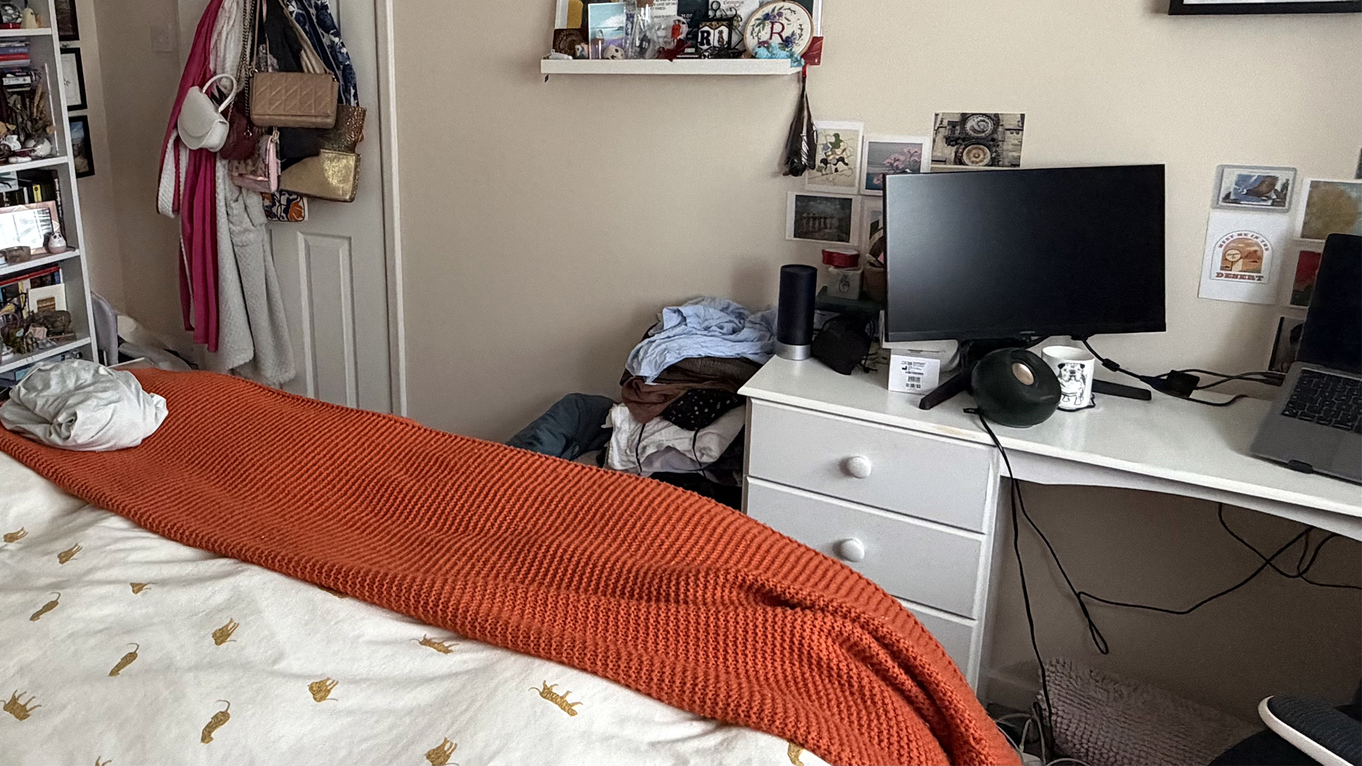A closeup from sleep writer Ruth Jones' bedroom showing a desk shelving, all covered with trainkets and clutter