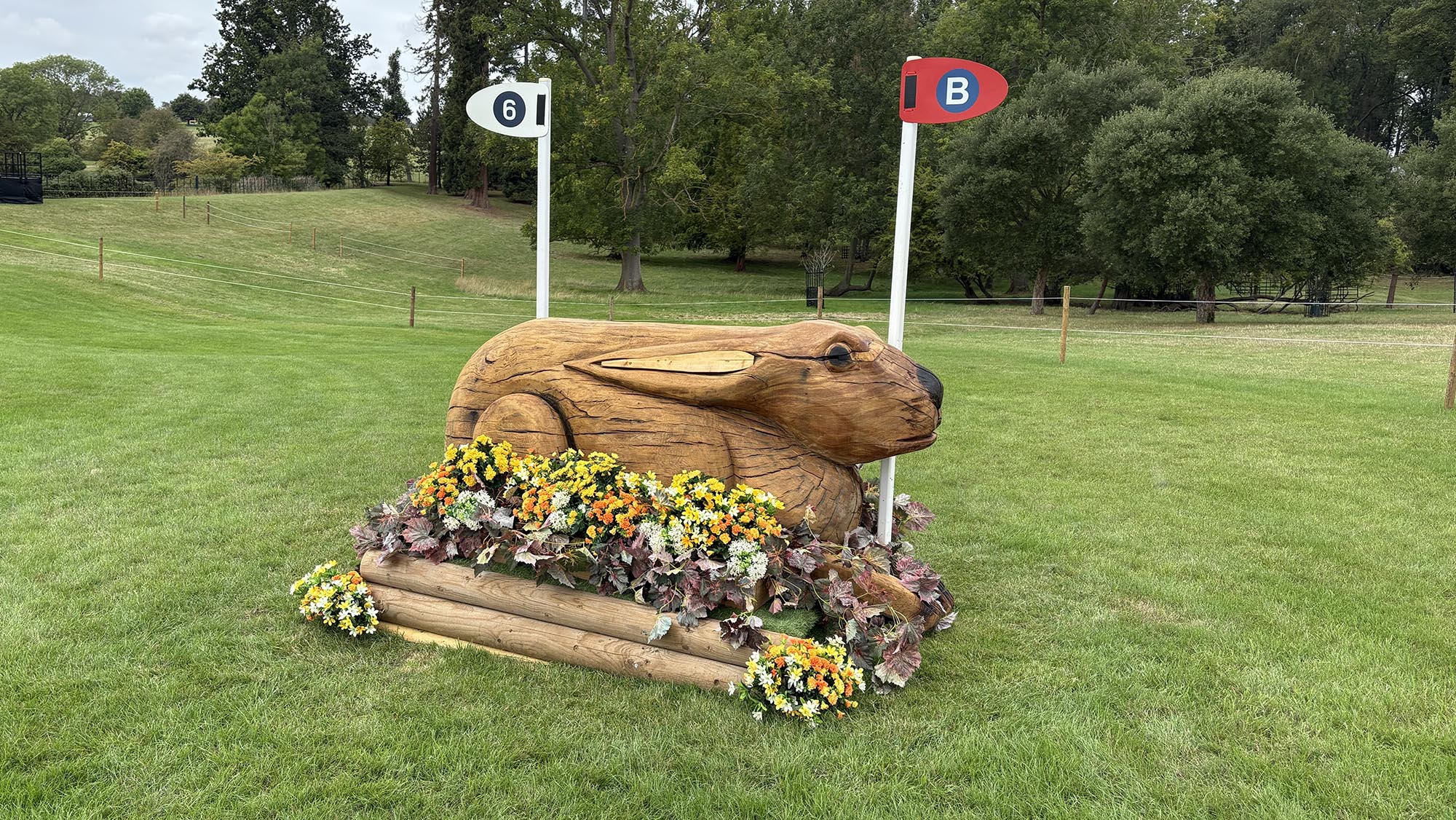 Narrow wooden fence carved like a hare on the Burghley cross-country course 2026