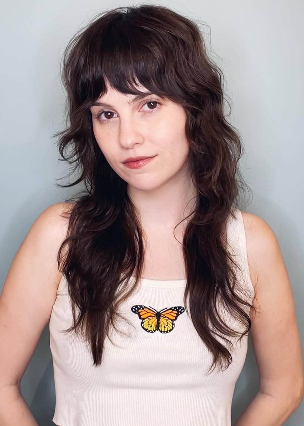 A model wearing their hair in a shag haircut.