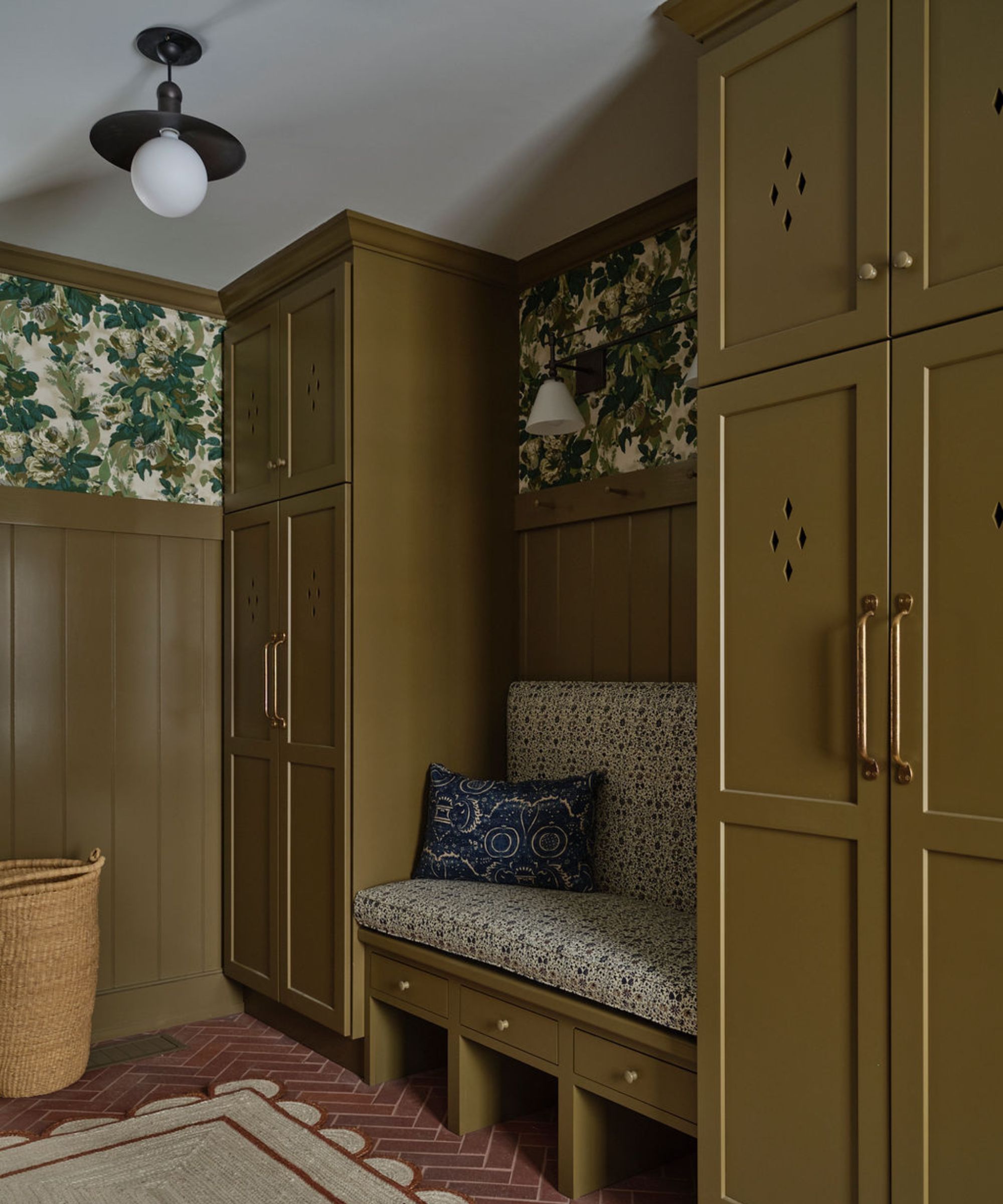 A muddy green boot room with cabinet cutouts