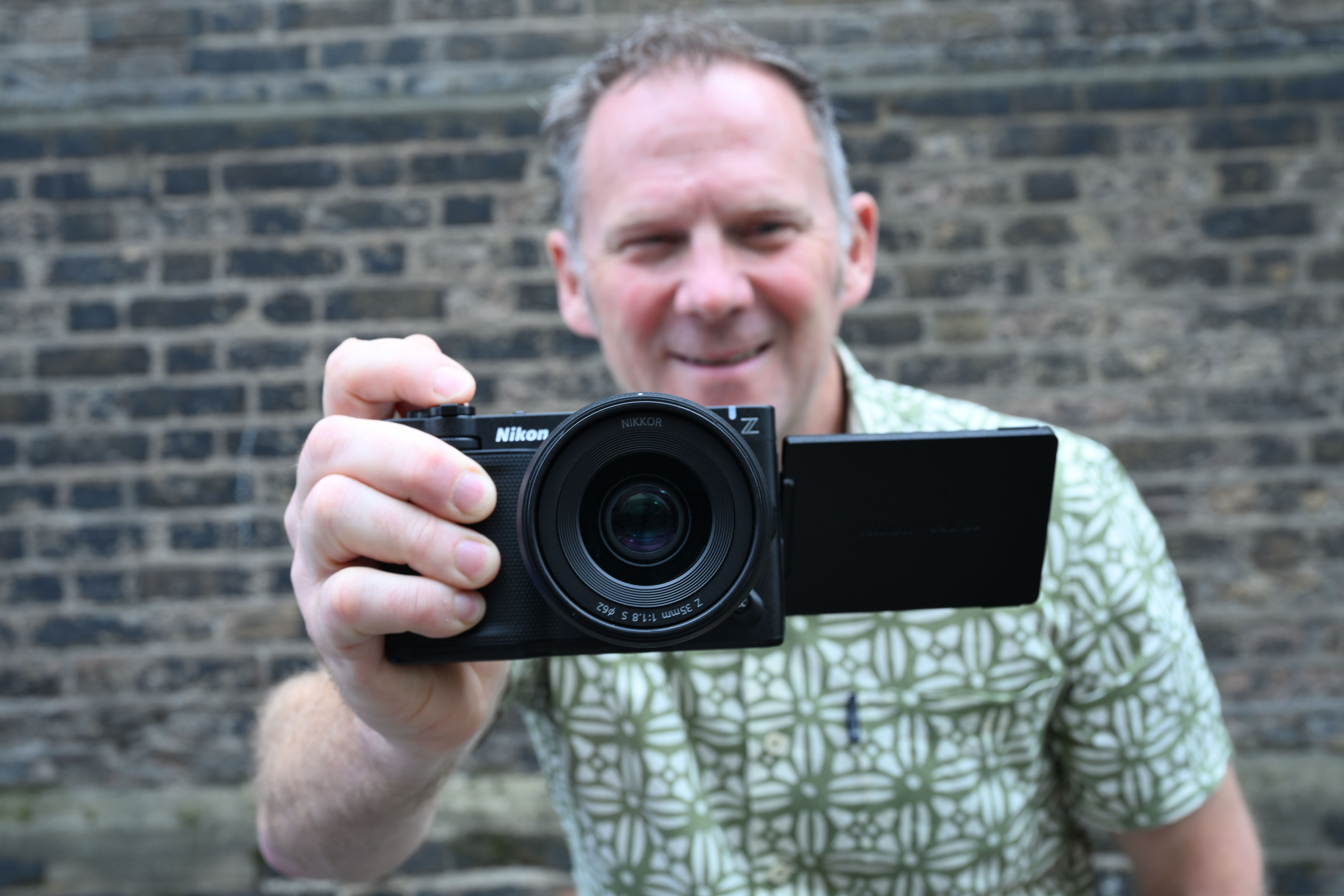 Man holding Nikon ZR video camera