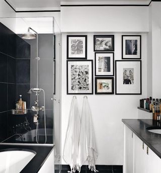 bathroom with frame on wall and shower with basin