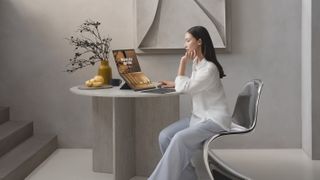 A woman uses the Asus Zenbook Duo