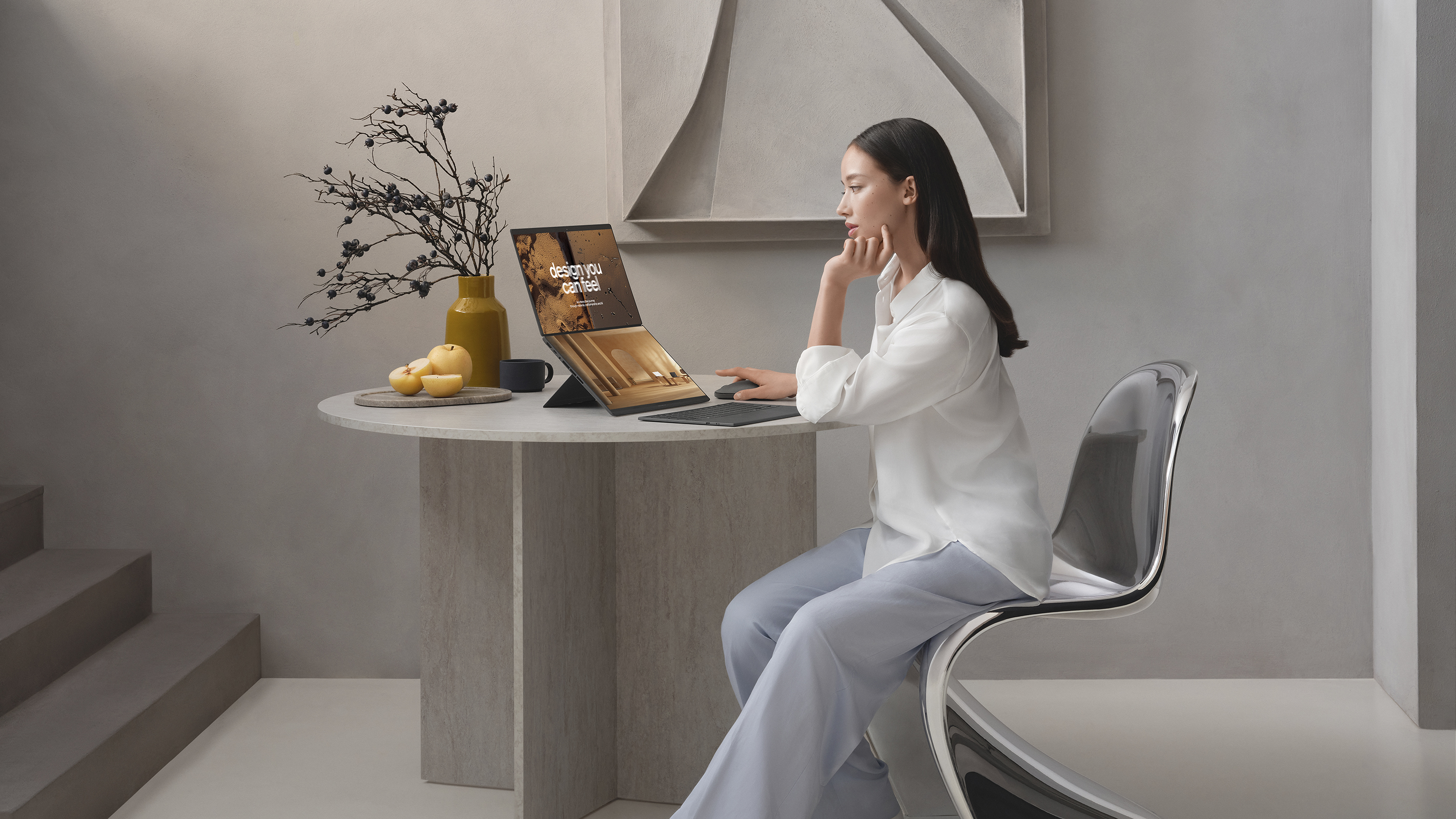 A woman uses the Asus Zenbook Duo