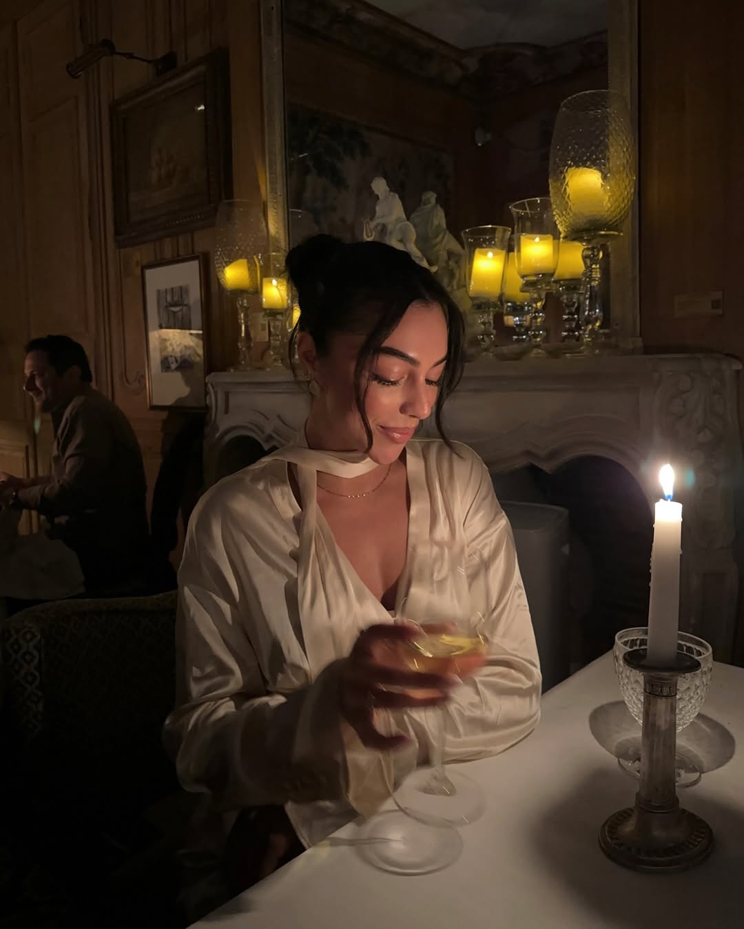 Mobina Peiman wears glowing makeup and up-swept hair while dining in Paris.