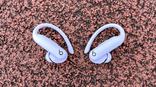 Beats Powerbeats Pro 2 headphones on a running track outdoors