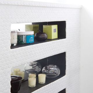 shelves on white wall and mirror