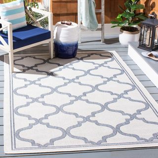 blue and white outdoor rug on a balcony