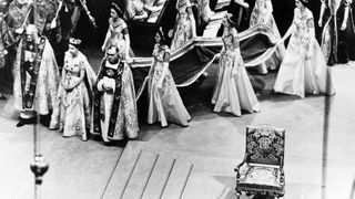 Queen Elizabeth II, surrounded by the bishop of Durham Lord Michael Ramsay (L) and the bishop of Bath and Wells Lord Harold Bradfield, walks to the altar during her coronation ceremony