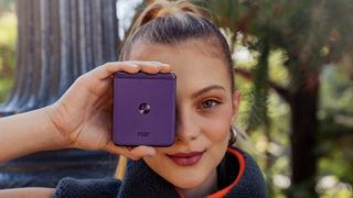 Motorola Razr 40 / Razr (2023) in purple held by smiling woman in front of face