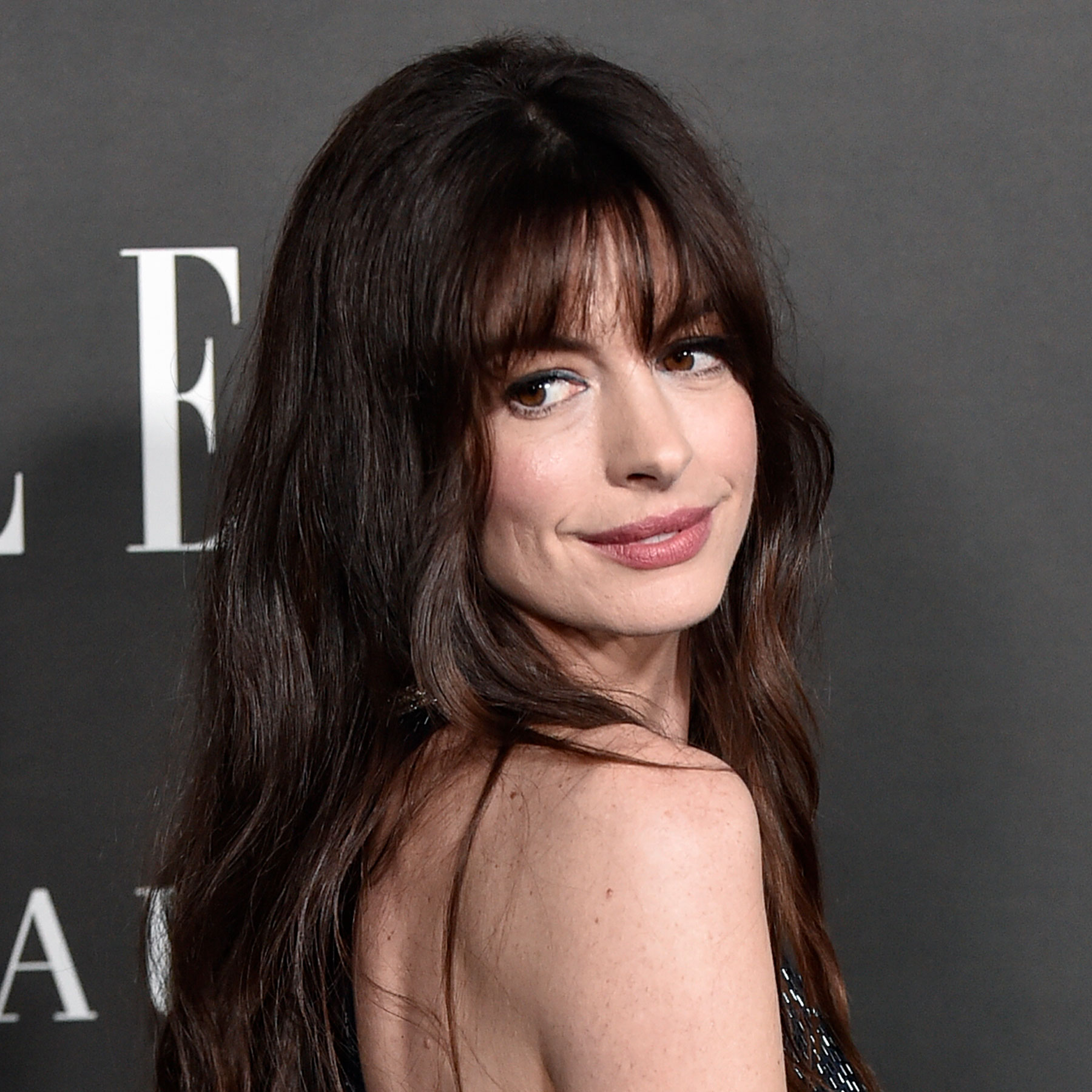 Anne Hathaway looks over her shoulder on the red carpet