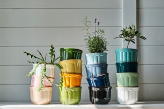 Several colourful plant pots stacked on top of each other.