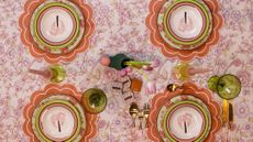 Ro'Table table setting featuring scalloped placemats, a floral tablecloth, and vintage-inspired palm-motif plates