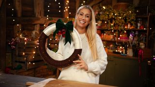 Stacey Solomon holding a Christmas pudding wreath in Stacey Solomon's Crafty Christmas 2023