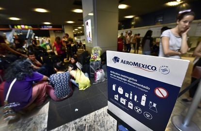 Passengers in Madrid wait to get a seat on an Aeromexico flight