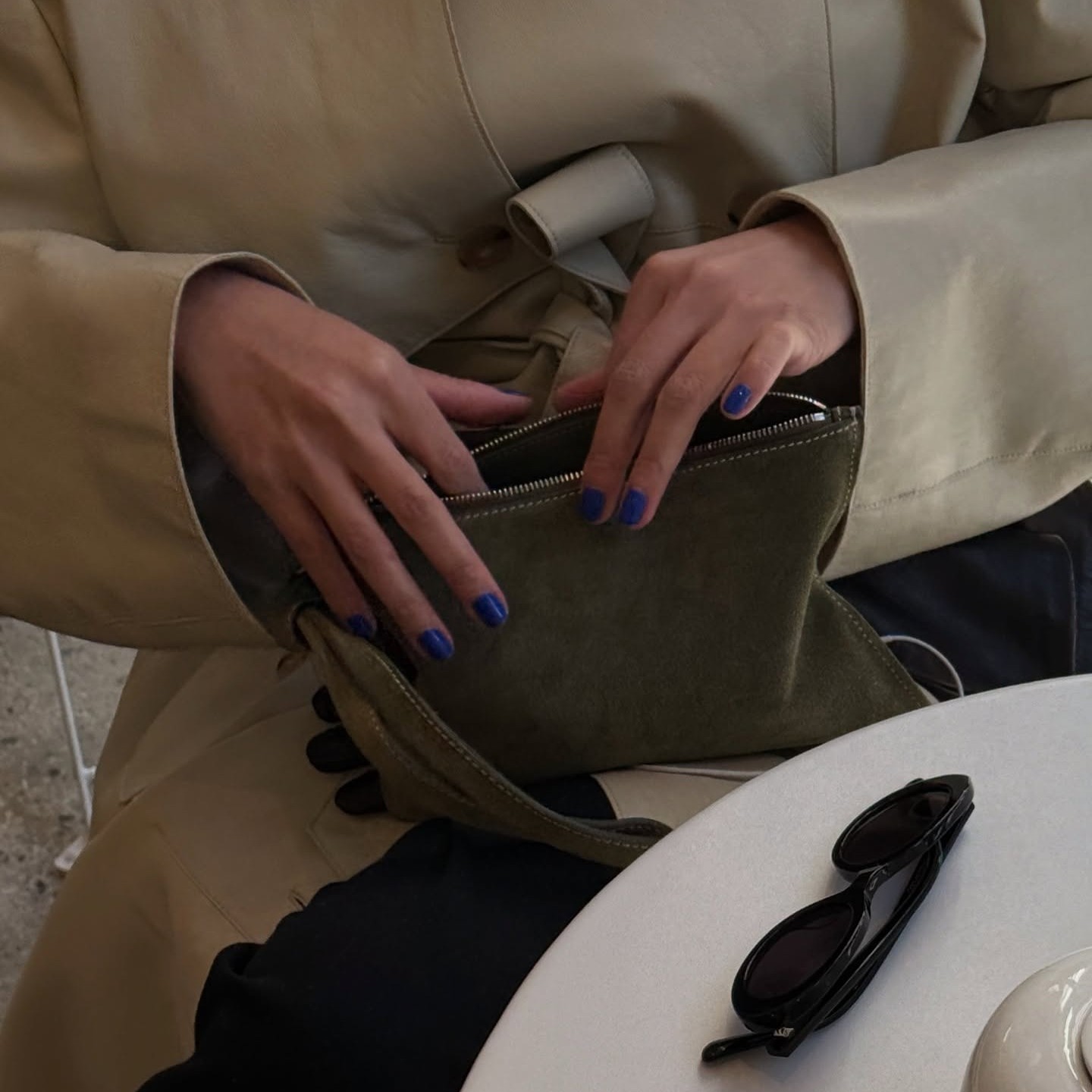 Creator @mimixn reaching into her bag at a cafe 
