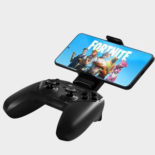 The SteelSeries Stratus+ on a plain background holding a mobile phone that's playing Fortnite