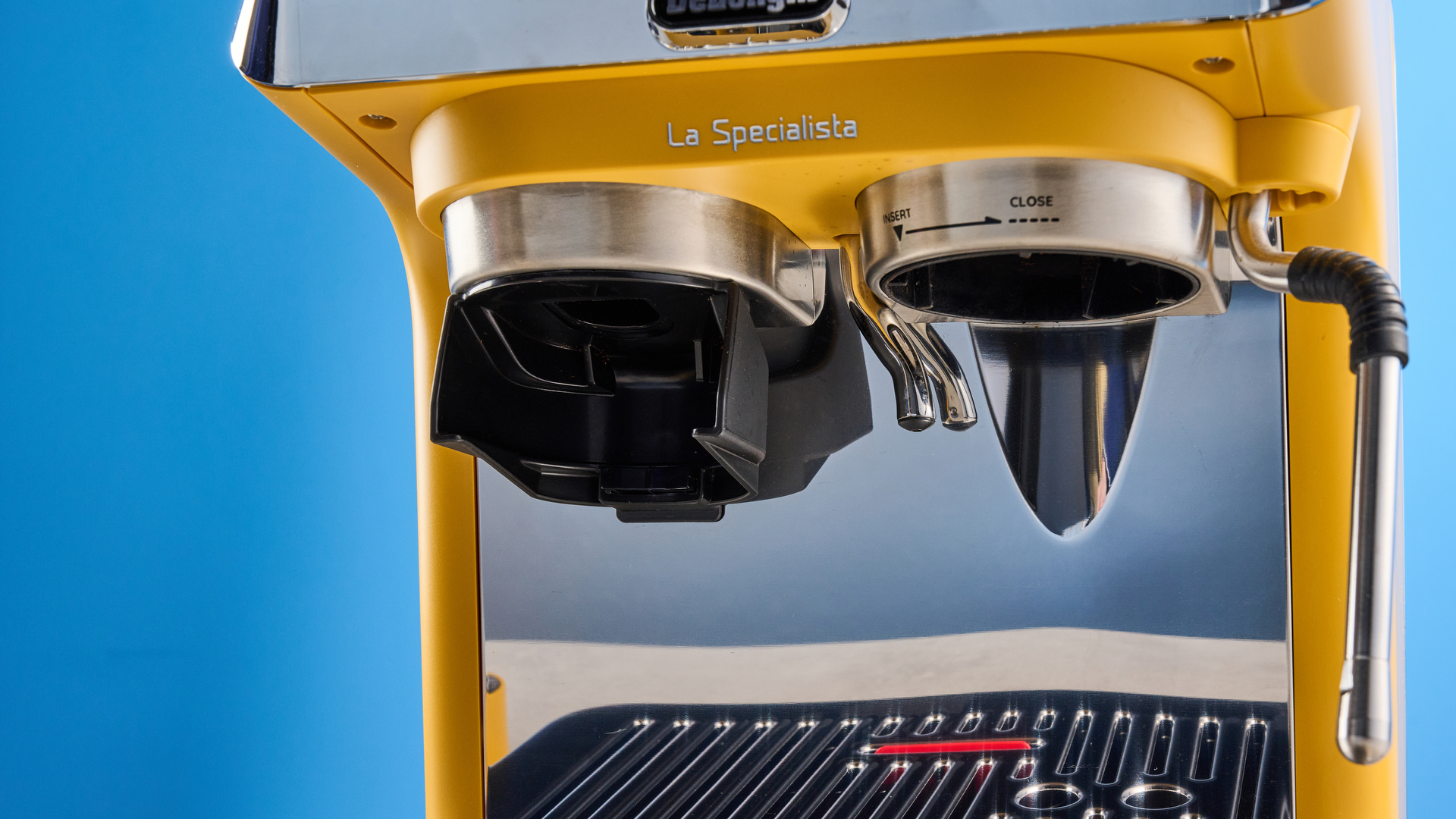 the de&#039;longhi la specialista arte evo special edition truestart edition, with yellow body, showing the espresso machine attachments like tamper, tamping collar, grinder, and control buttons