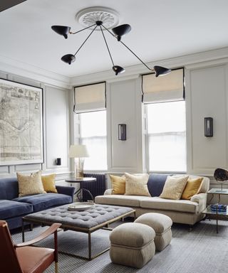 Living room ceiling light ideas with a black sputnik chandelier with blue sofas in a white room