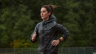 Woman running wearing Garmin Forerunner 255 watch