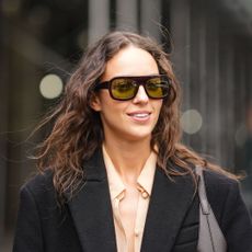 woman with ghost waves on brunette hair wearing sunglasses and wool blazer