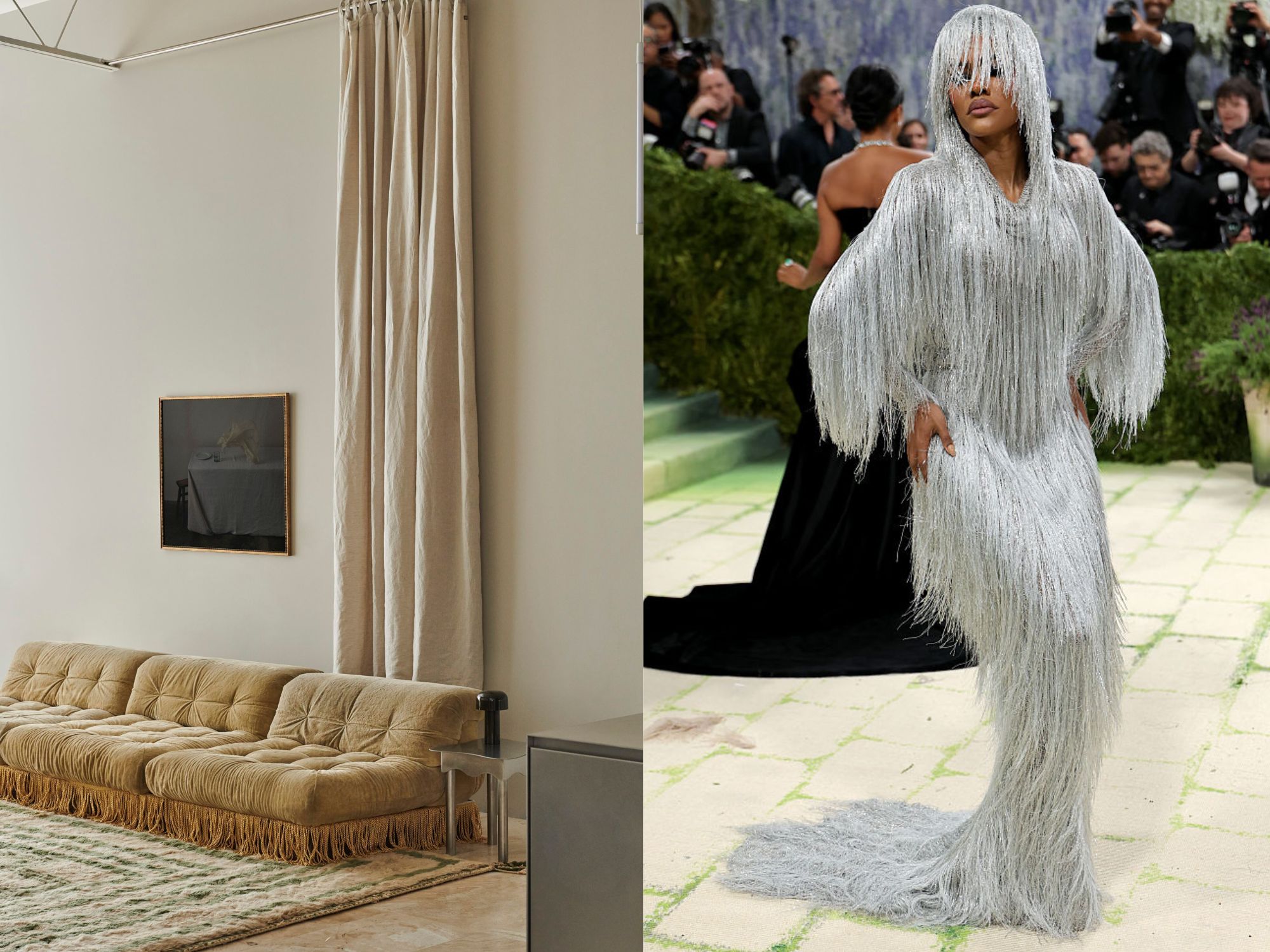 A chrome side table is next to a beige sofa and Black painting is hung on the wall. Teyana Taylor wears a chrome silver fringe hat and dress.