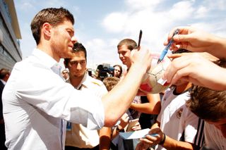 Xabi Alonso signs autographs after signing for Real Madrid in 2009.