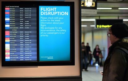 An information board displays flight information follwing disruption, in the South Terminal building at London Gatwick Airport, south of London, on December 21, 2018.