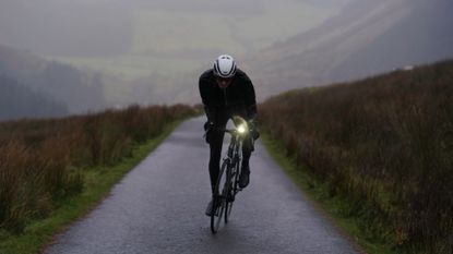 Image shows a rider using one of the best bike lights