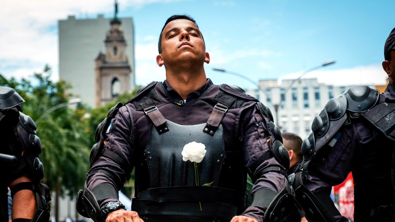 A riot police officer protests against austerity measures in front of the Rio de Janeiro state assembly