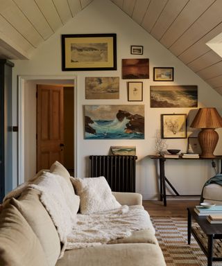 neutral living room with panelled rustic ceiling, neutral couch and a gallery wall