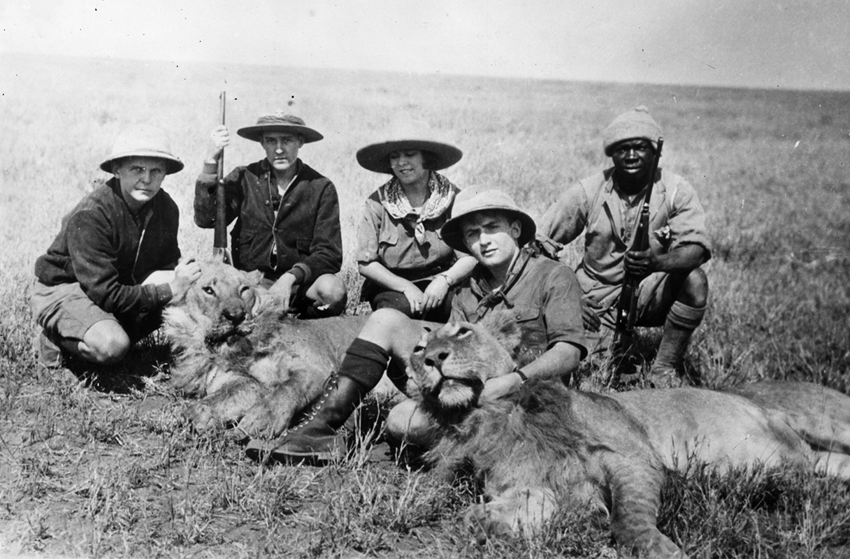 American anthropologist Osa Johnson and Jerramani, her African guide (right) pose with two dead lions in East Africa, in April 1930. With them are three Eagle Scouts who won a national Boy Scout competition to go on safari with the Johnsons in 1928, later writing the book &#39;Three Boy Scouts in Africa&#39;. From left to right they are Robert Dick Douglas, Doug Oliver and David Martin.