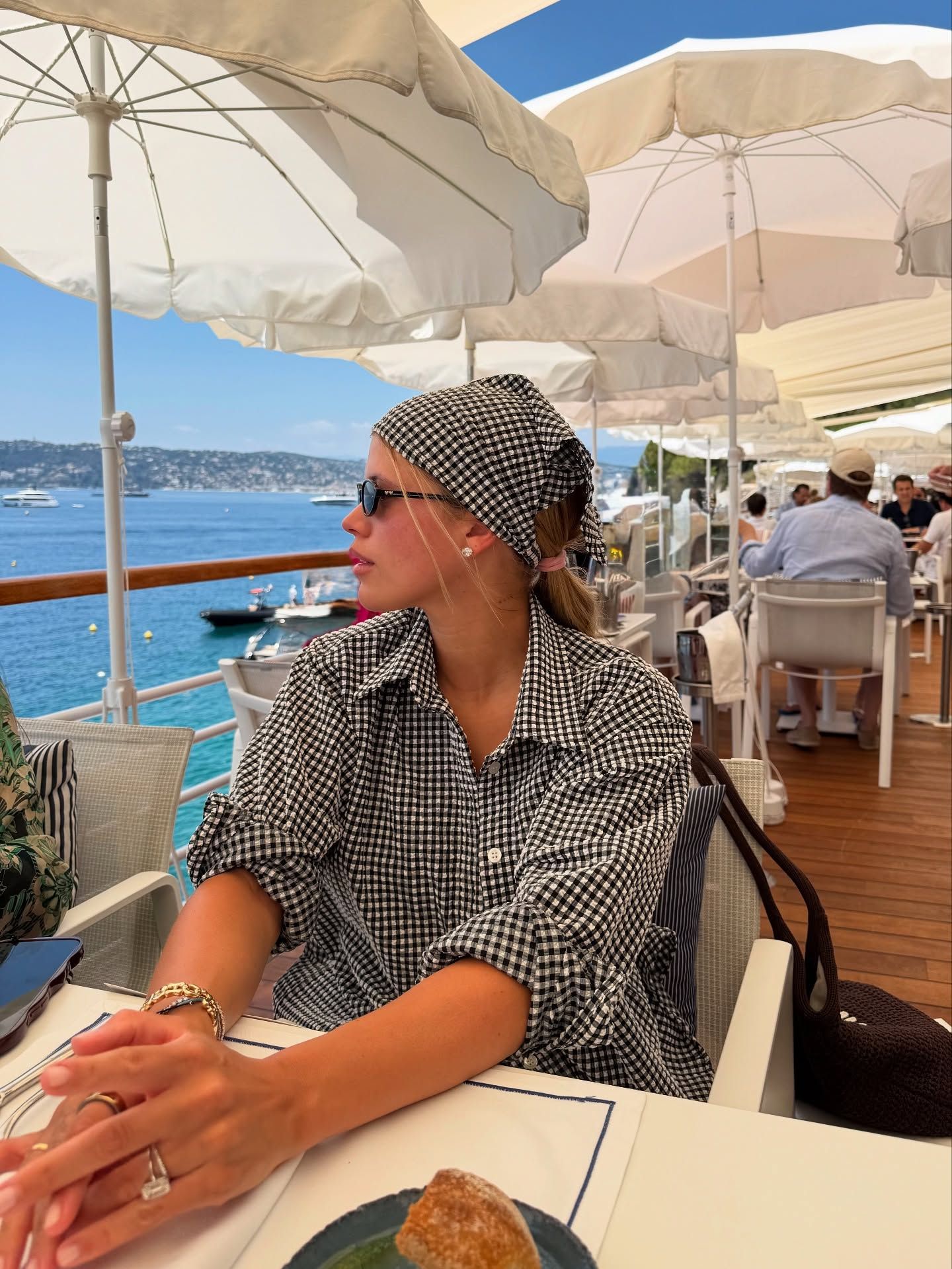 An image of @sofiagrainge wearing a bandana, one of the biggest summer accessories.