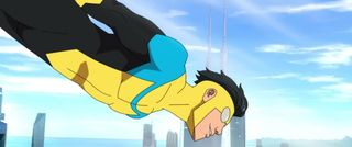 The superhero known as Invincible flies through the skies in front of a cityscape