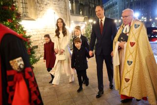 Kate Middleton, Prince William, and their three children with the Dean of Westminster Abbey at the "Together At Christmas" Carol Service at Westminster Abbey on December 08, 2023.