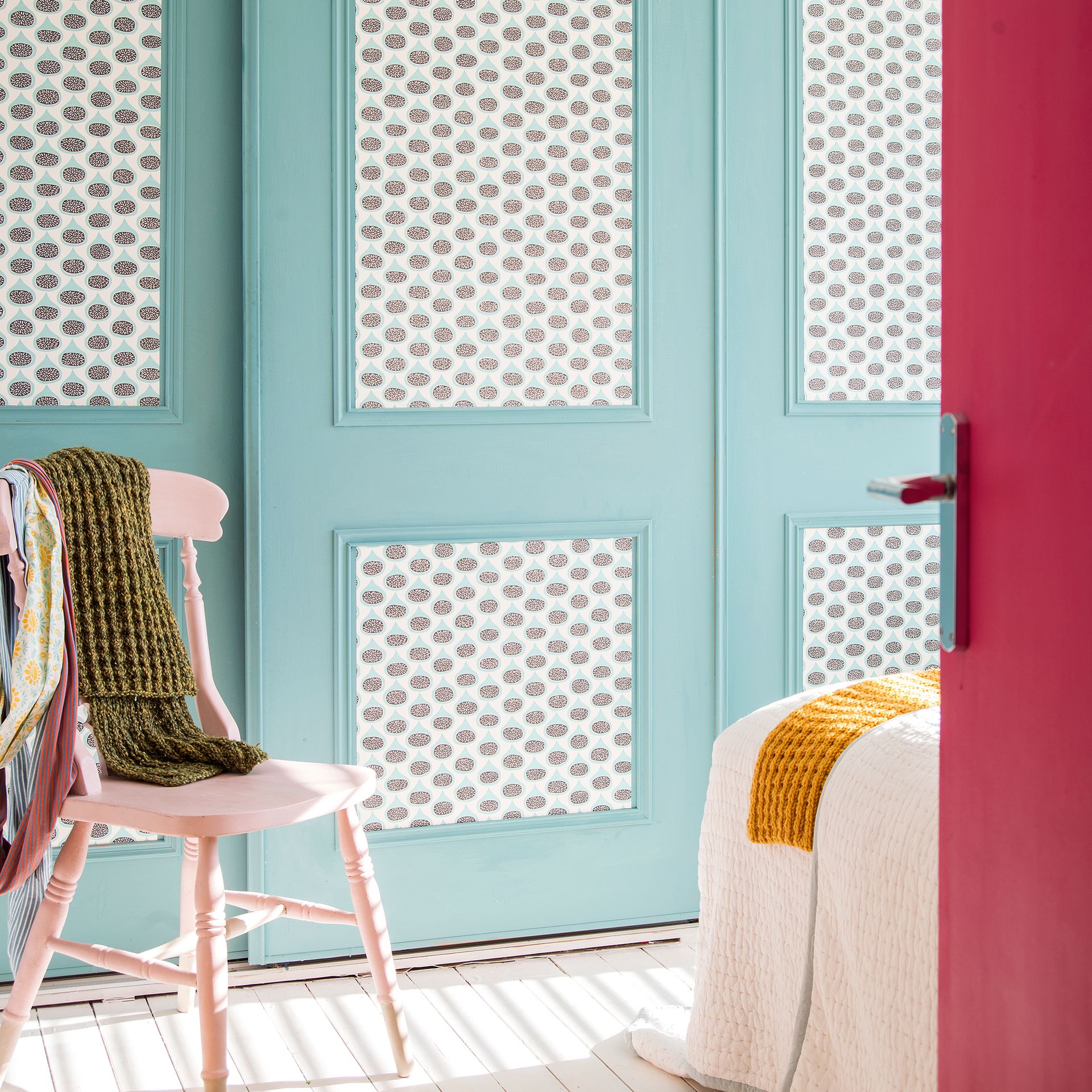 Bedroom with built in wardrobes painted baby blue with wallpaper panelling