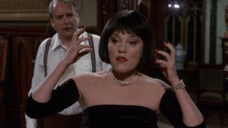 Mrs. White with her hands by her face in Clue