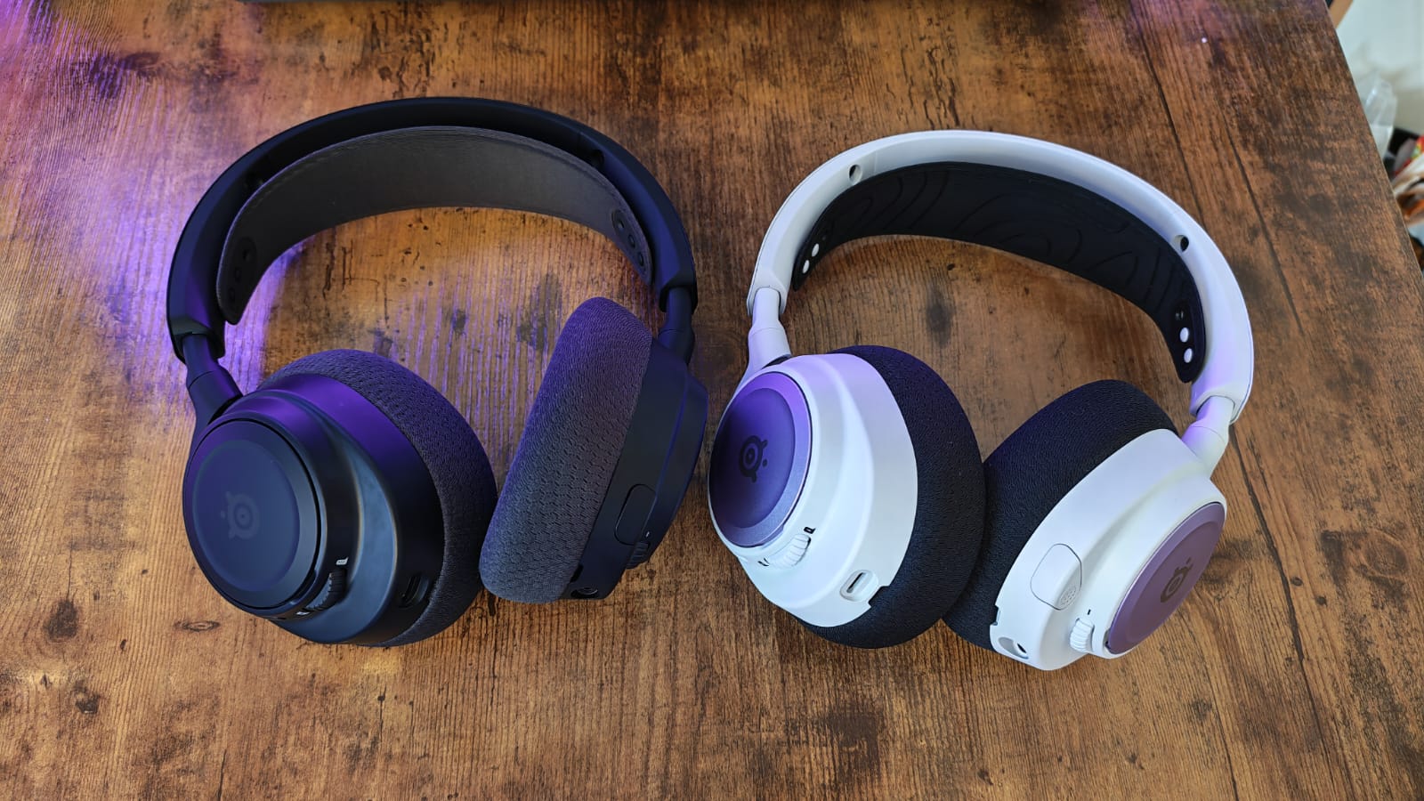 The SteelSeries Arctis Nova 7 Gen 2 next to a white SteelSeries Arctis Nova 7 headset