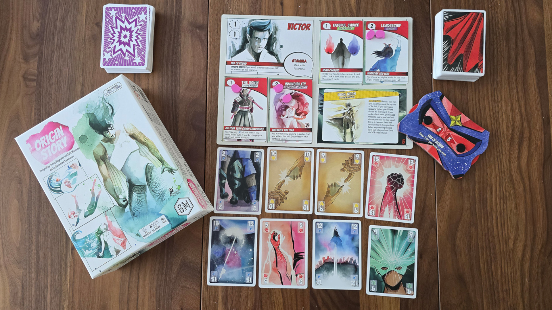 Origin Story box and cards laid out on a wooden surface