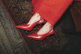 A closeup of the 24-year-old accessorizing her slinky gown with matching red slingback heels from Jimmy Choo.