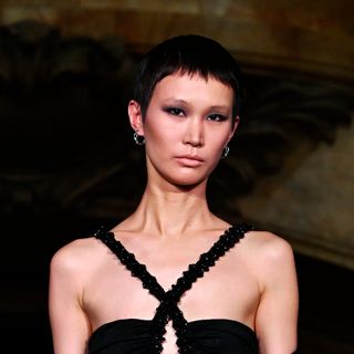 A model wears a black velvet halter-neck thong bodysuit with a cutout panel in the bodice and a sheer panel alongside the waist at the PatBo runway show at Surrogate's Court during New York Fashion Week on February 10, 2024 in New York City.