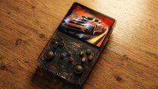 R36S retro gaming handheld on a wooden desk
