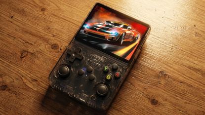 R36S retro gaming handheld on a wooden desk