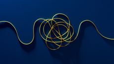 A tangled yellow cord against a dark blue background.