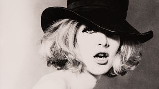The cover image for Cowboy Kate & Other Stories (1964), a close-up portrait of a woman in a black hat with tousled blonde hair falling across one eye.