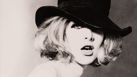 The cover image for Cowboy Kate & Other Stories (1964), a close-up portrait of a woman in a black hat with tousled blonde hair falling across one eye.
