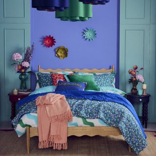 A bedroom decorated with pieces from Sophie Robinson's collection for Dunelm including floral bedding and patterned cushions